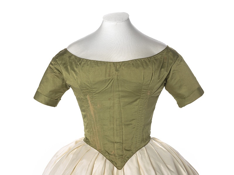A green bodice from an 1880s garment on a white background