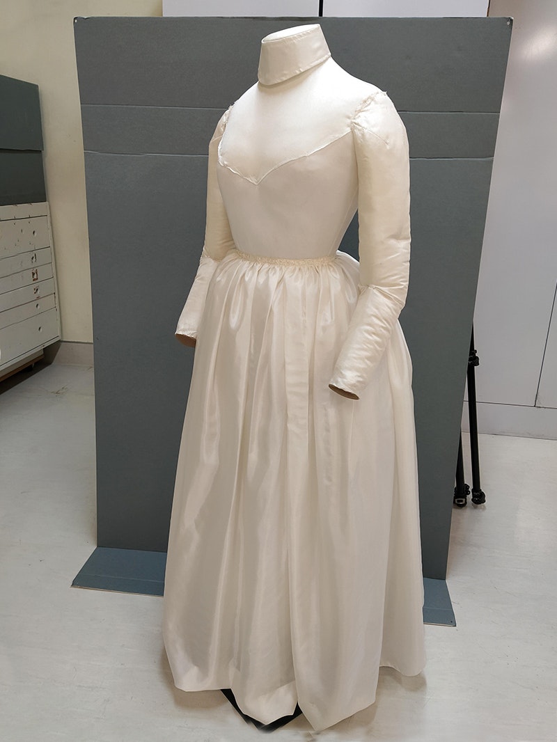 A dressmaker's dummy with white padded dress waiting for the finished dress.