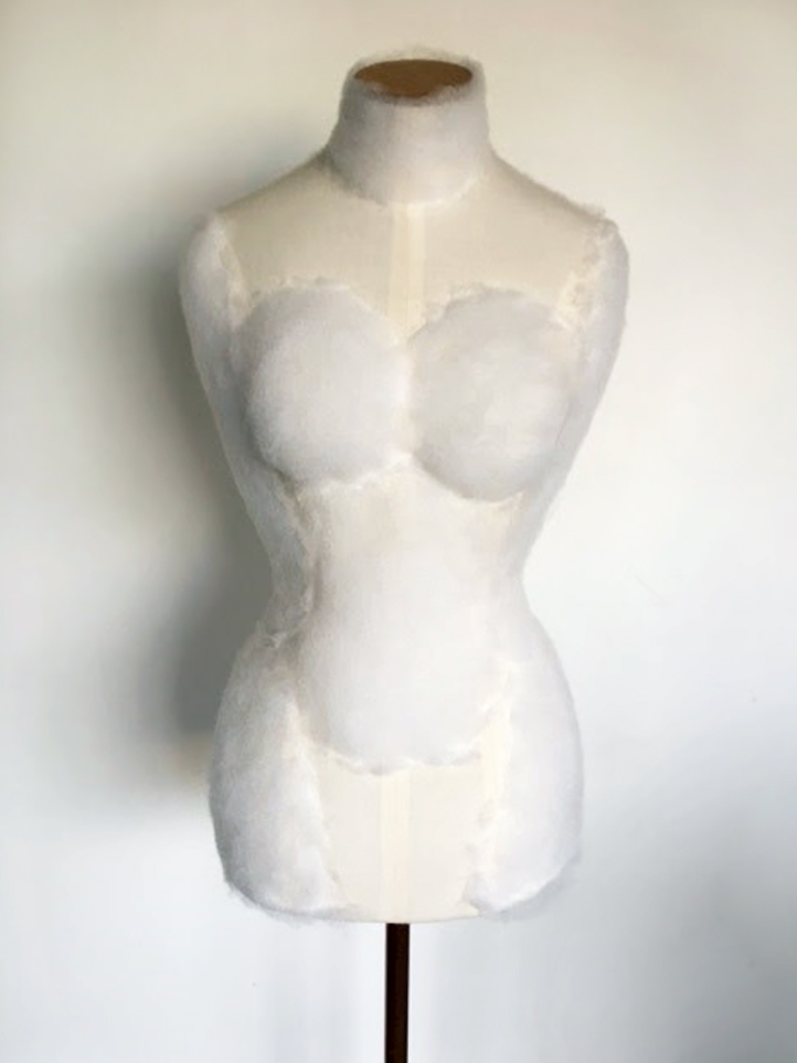A dressmaker's dummy with dacron padding attached to it