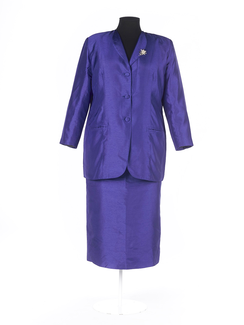 A blue silk suit jacket and skirt on a dressmaker's dummy