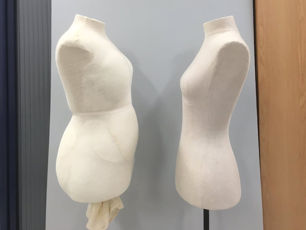 Two side-on dress mounts facing each other. One has padding and the other doesn't.
