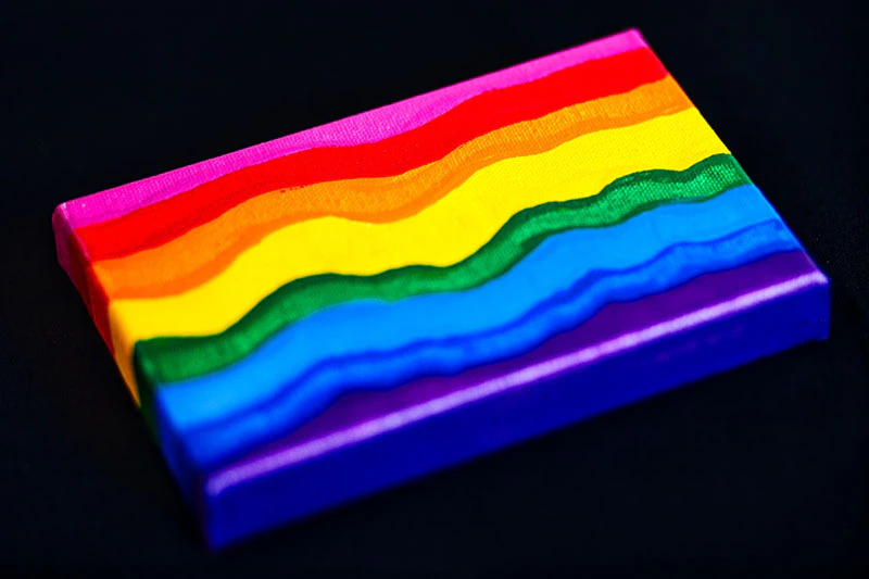 A painting of a rainbow on a small canvas