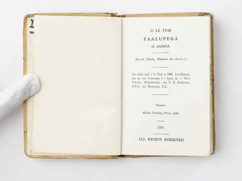 An open book with Sāmoan text printed on the page