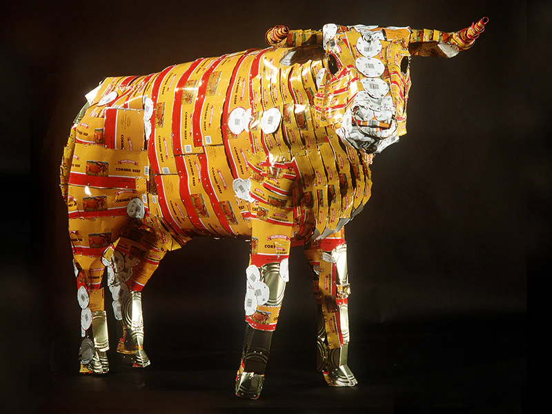 A sculpture of a steer made from flattened corned beef cans