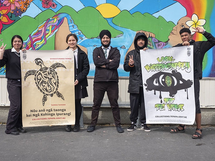 Taita College students Ema Pasikala, Vika Tupou, Jaspreet Singh, Hunter Robinson, and Junior Misa with their posters, 2021. Photo by Daniel Crichton-Rouse. Te Papa Five students stand holding two large posters