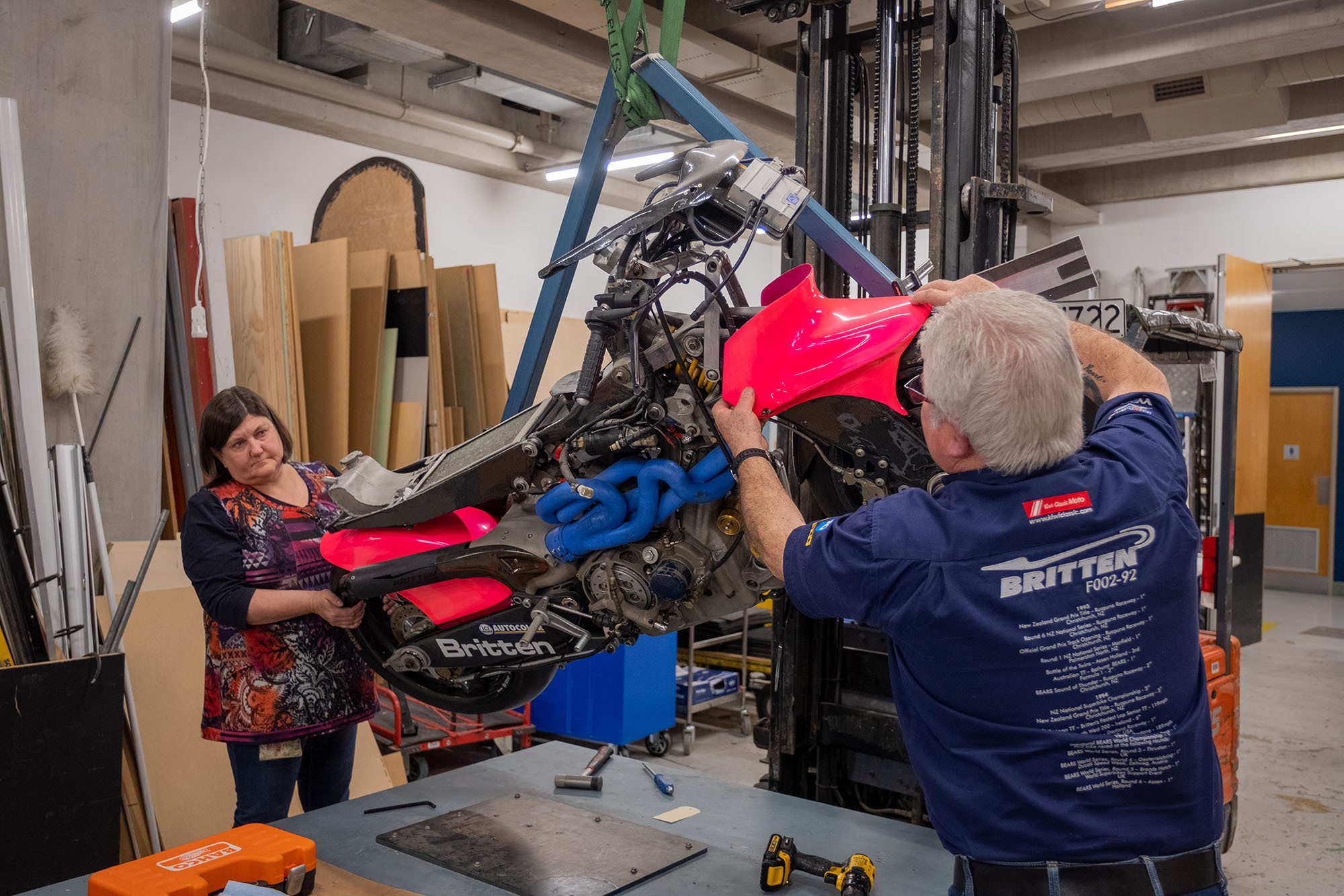 Bob removes the front mudguard while Carolyn holds the bike steady