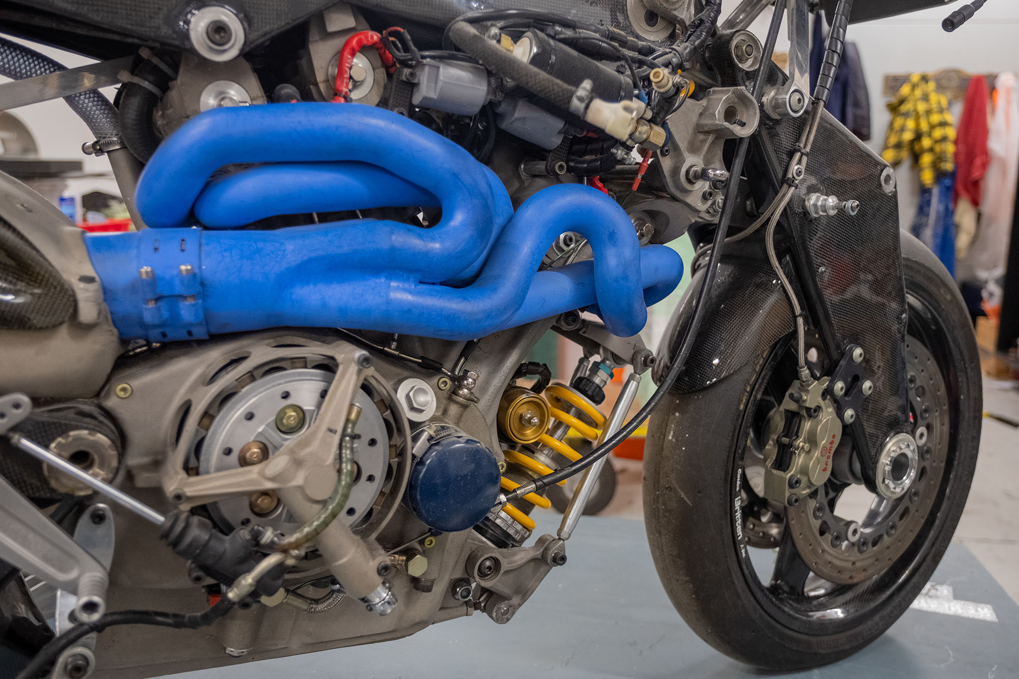 Close up of the bike’s bright blue exhaust system, an organic-looking system of tubes