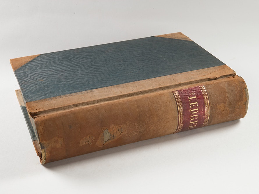 An old leather-bound book with a green cover