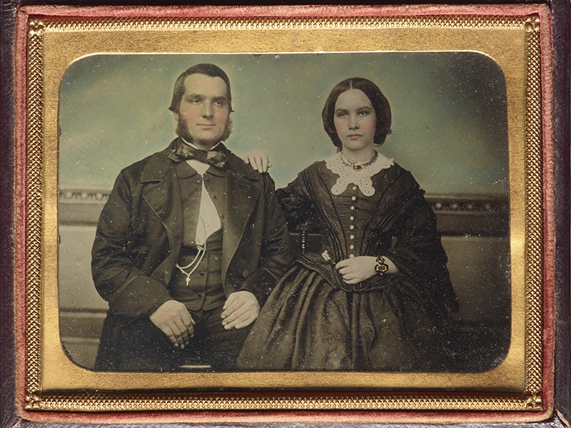A studio photograph of a man and a woman that has been hand coloured