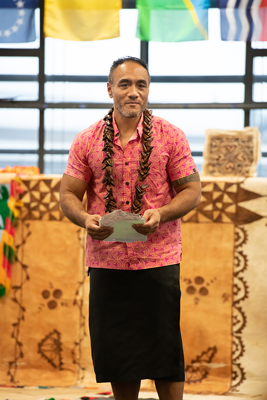 A man in a room wearing traditional Sāmoan clothing
