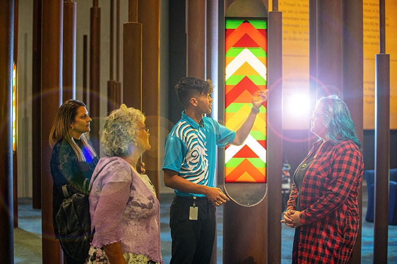 A Te Papa host guides visitors through the museum
