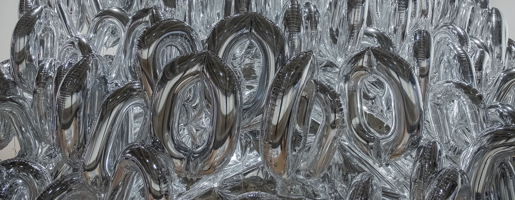 Close-up of Mikala Dwyer’s The silverings, featuring inflated silver balloons shaped like zeroes