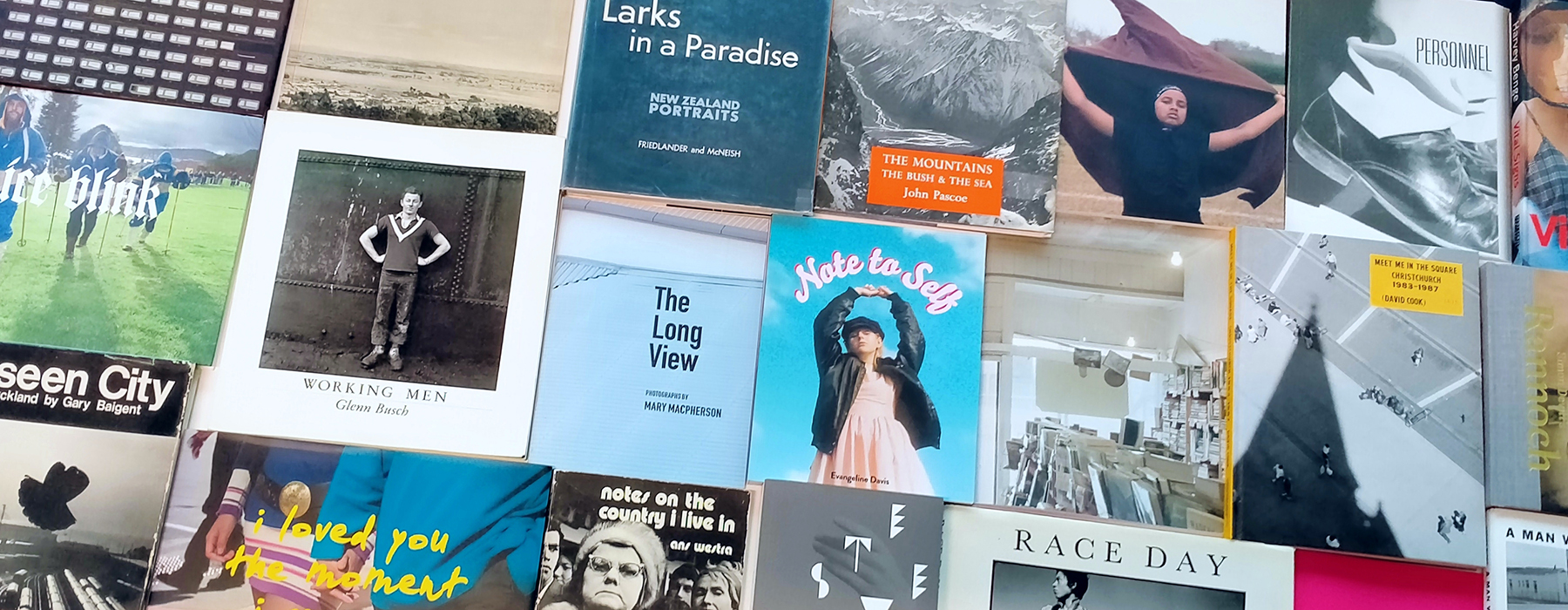 A selection of photographic books laid out on a table with their font covers showing
