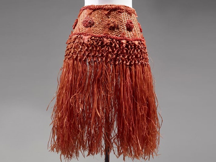 Patutiti (skirt), hibiscus fibre, Niue. Purchased 1973. Te Papa (FE006396) A burnt orange woven skirt on a model dummy