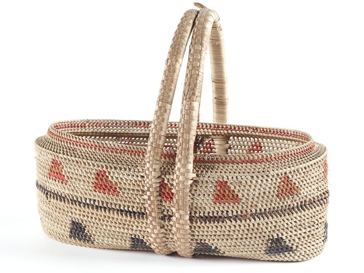 Kato (basket), Niue, about 1920s, pandanus fibre, artist unknown. Purchased 1931 (Te Papa FE007907) A woven basket sitting on a white background