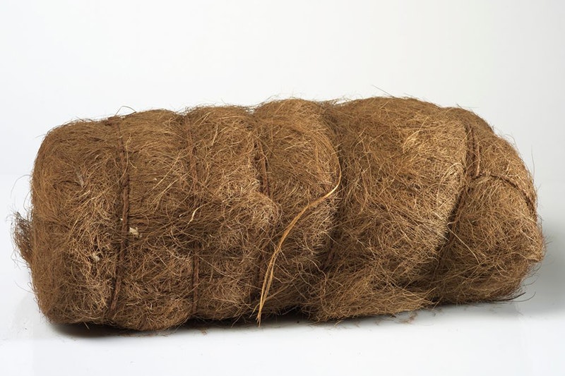 A bundle of brown fibre tied with string made from that fibre