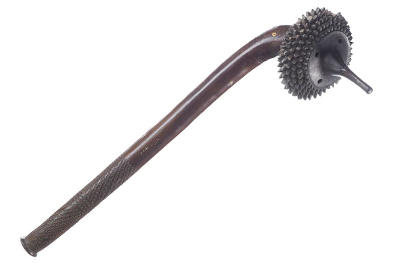 A wooden club with a round ball at the end with a pointed end