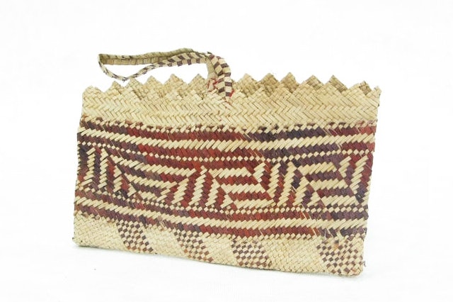 A woven basket on a light grey background