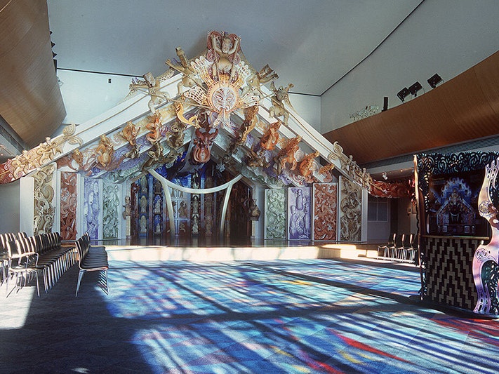Rongomaraeroa, 2013. Te Papa A colourful stage within a room with sunlight through coloured windows bathing the room in shades of blue and purple