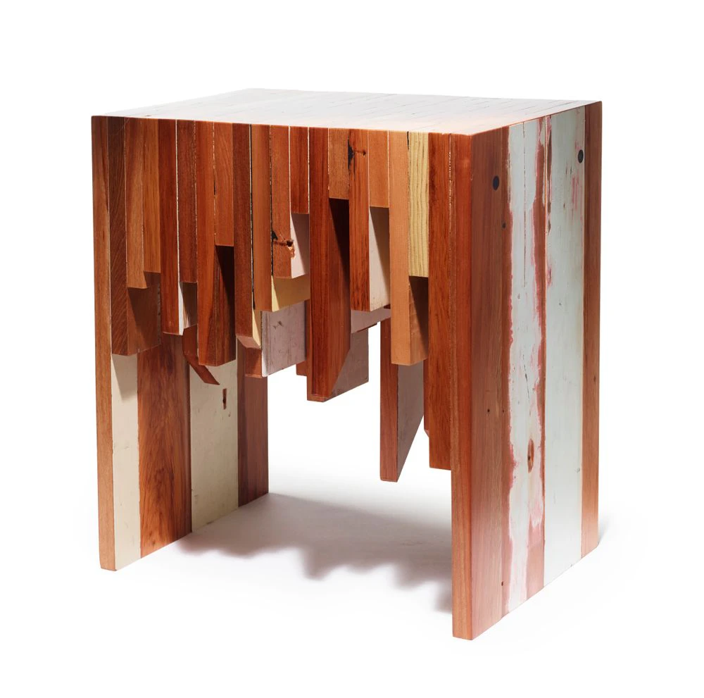 A wooden table made of several pieces of wood that are all different lengths.