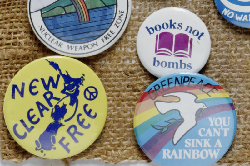 Close up of badges with anti-nuclear messages on them