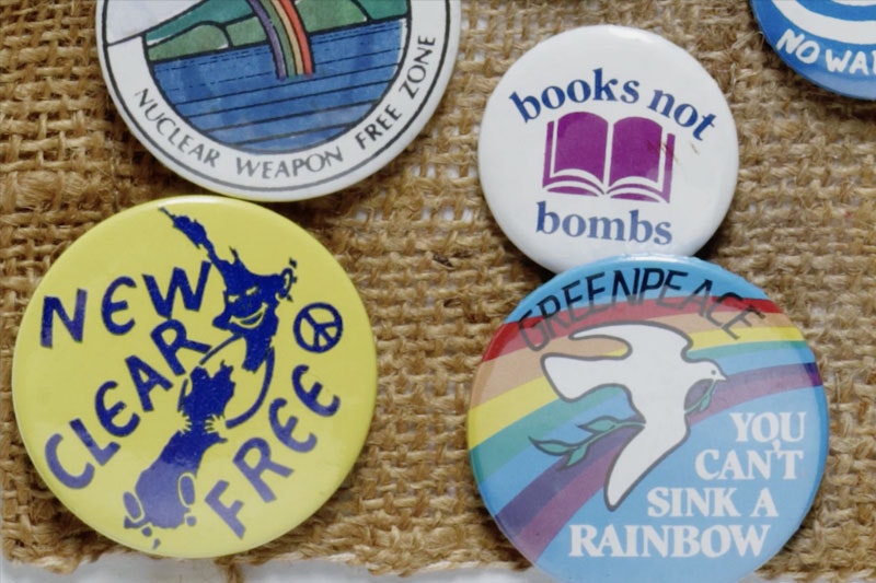 Close up of badges with anti-nuclear messages on them