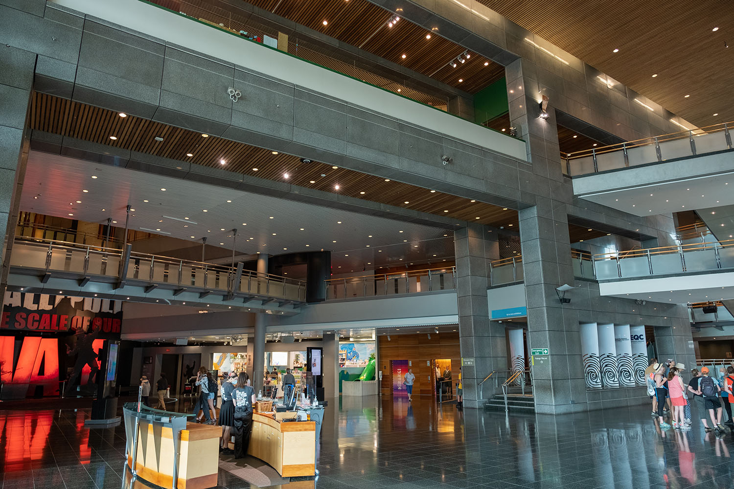 Two photos showing the large-scale concrete wall going through Te Papa representing the fault line that runs parallel to it