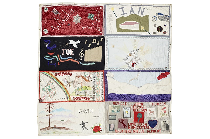 A patchwork quilt section with names and words on it in honour of people who have died from AIDS