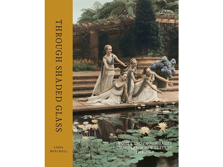 Cover of Through Shaded Glass Book cover with a four women dressed in togas leaning over a lily pond.