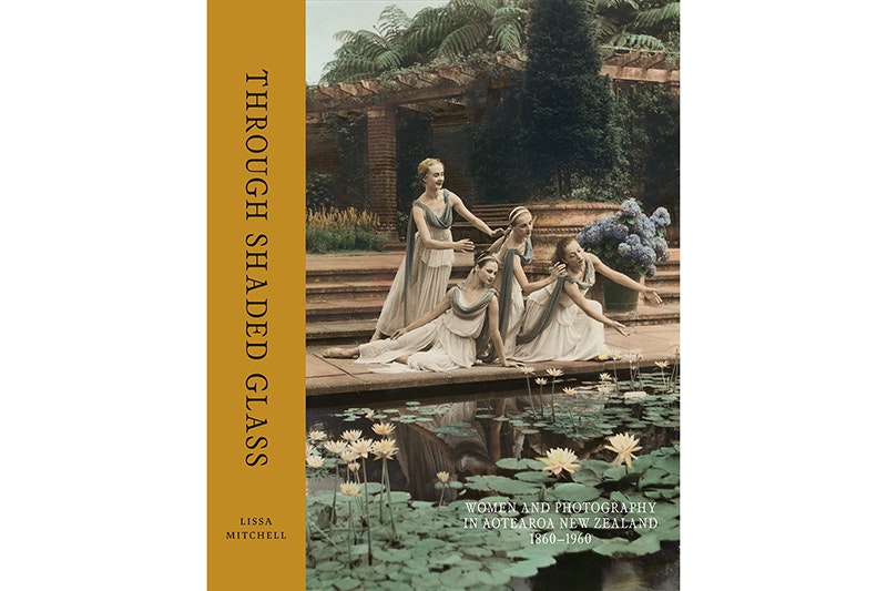Book cover with a four women dressed in togas leaning over a lily pond.