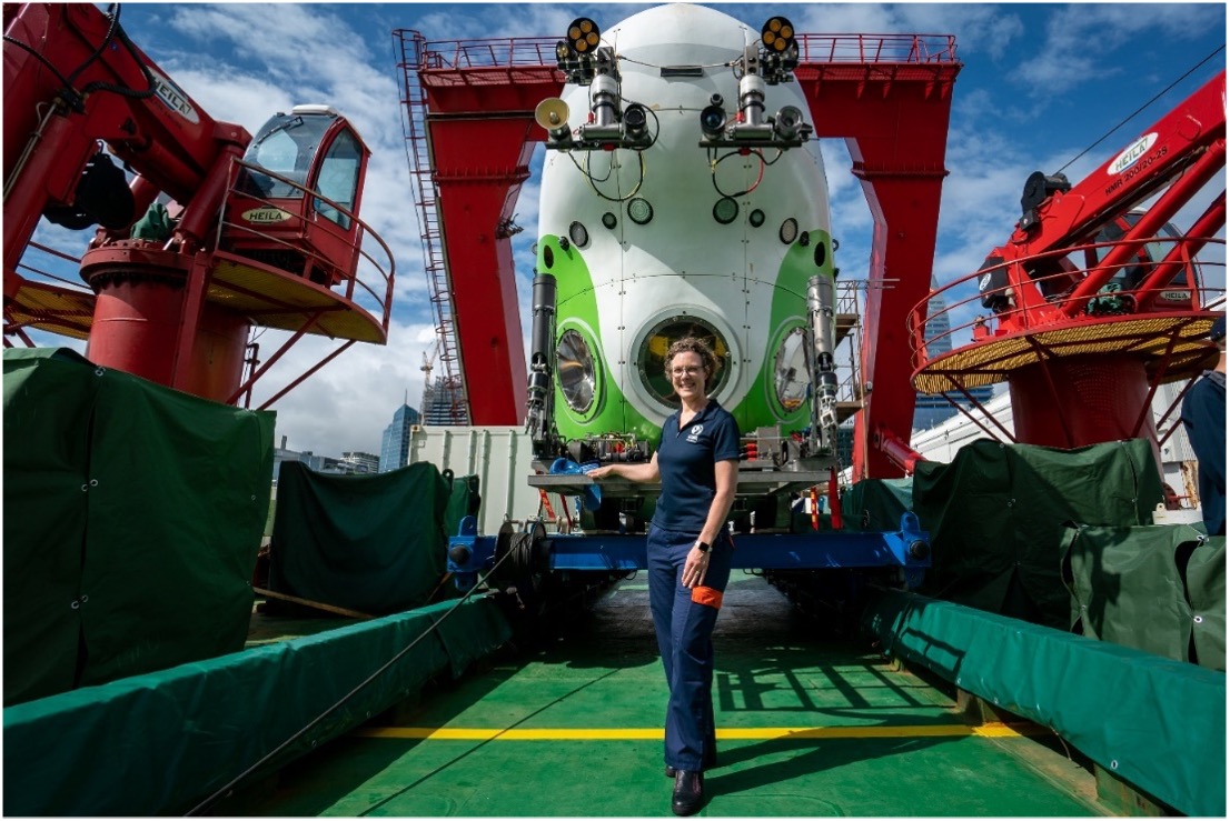 A woman is standing on a fishing boat.