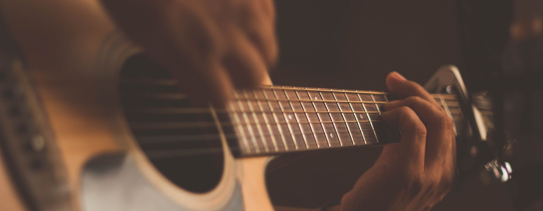 Close up of a person playing the guitar