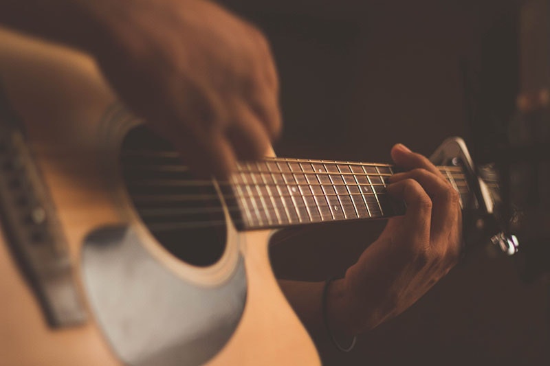 Close up of a person playing the guitar