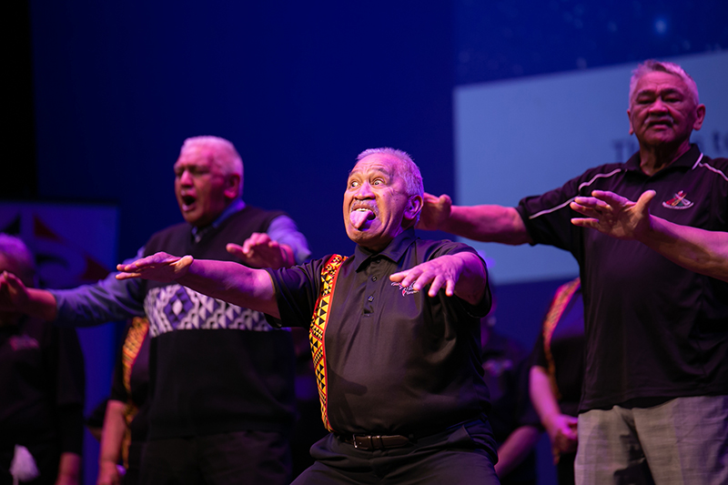three men performing on stage