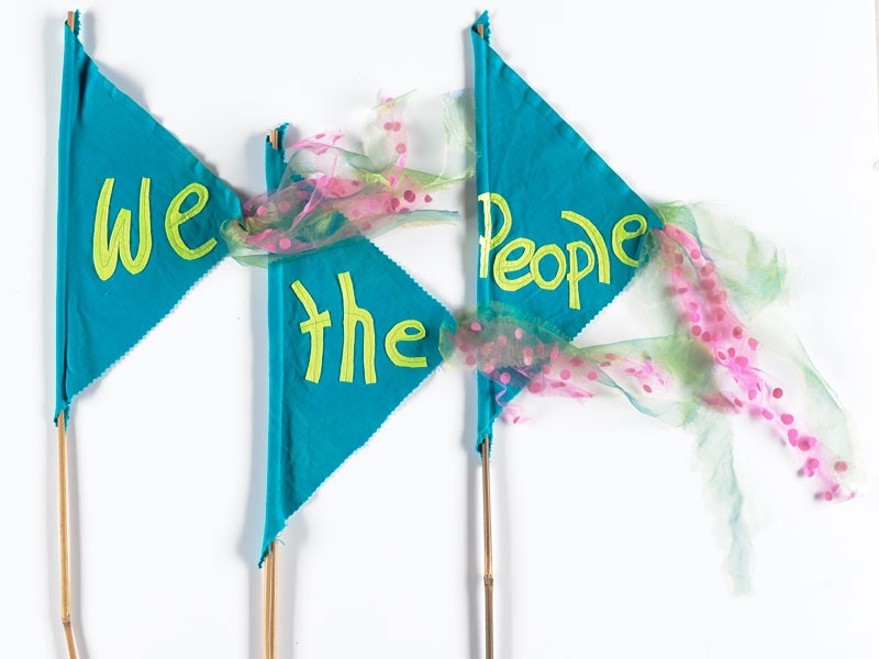 Blue flags which say 'We the People’.