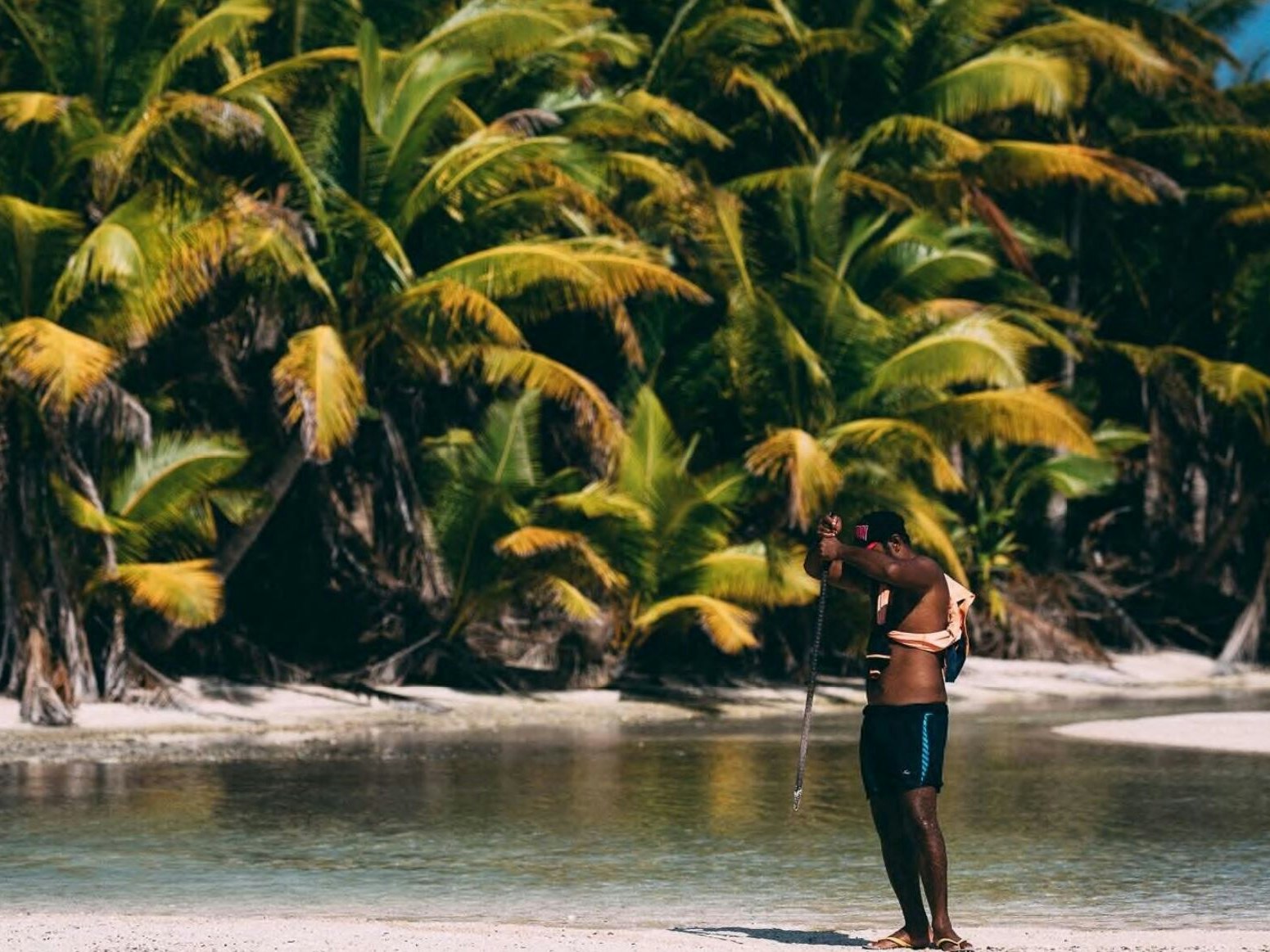 Man with rod, Atafu, Tokelau, Nov 2017, by Mr Andrew Matautia. Co-collected, 2017. Te Papa (O.047867) A man on a tropical island holds a rod