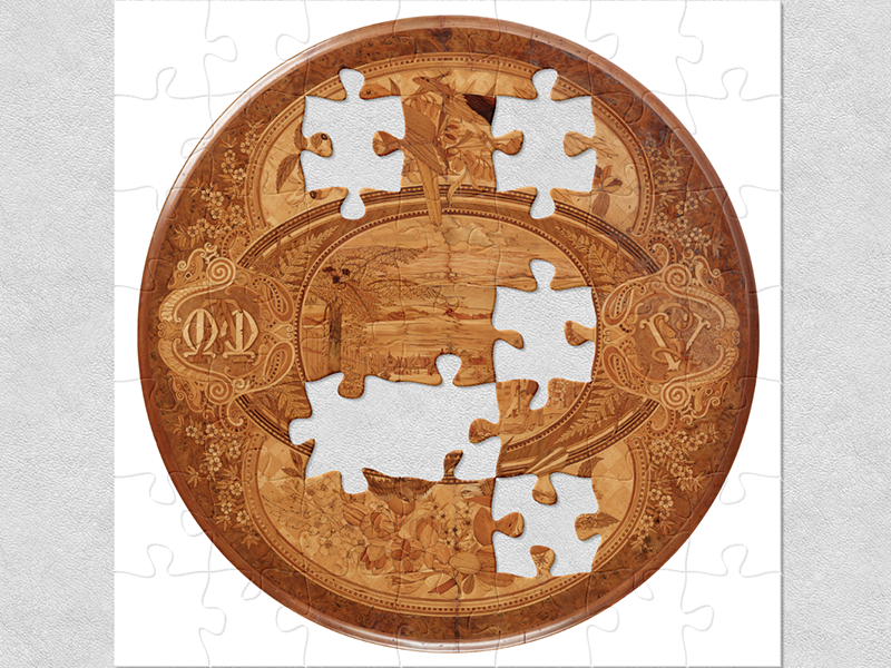 A circular wine or card tabletop with wooden marquetry made from indigenous New Zealand timbers