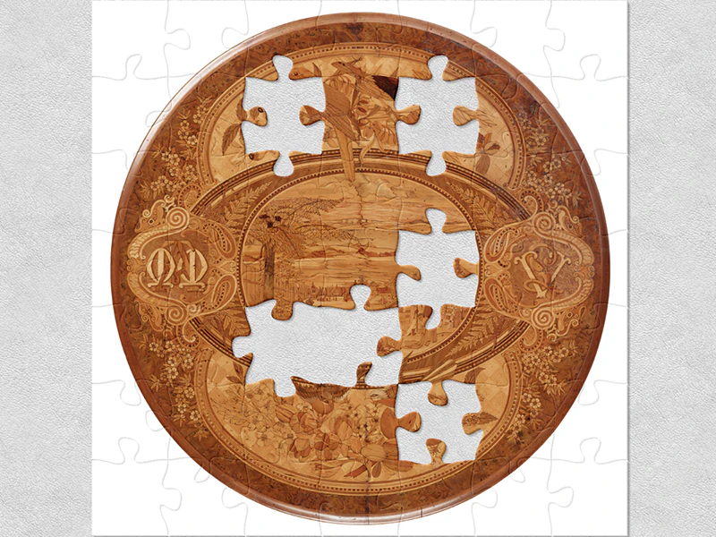 A circular wine or card tabletop with wooden marquetry made from indigenous New Zealand timbers