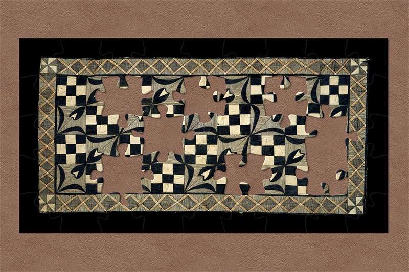 Tapa cloth. The border is a network of orange Xs, while the internal patterns alternate between checkerboards and flowers