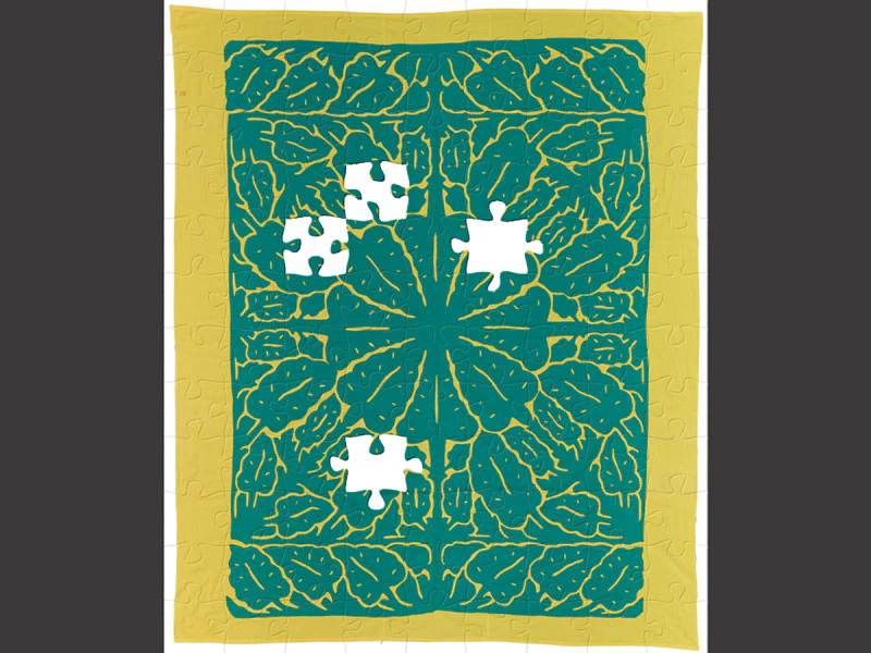 Puzzle of a turquoise and yellow patterned quilt with leaves on it