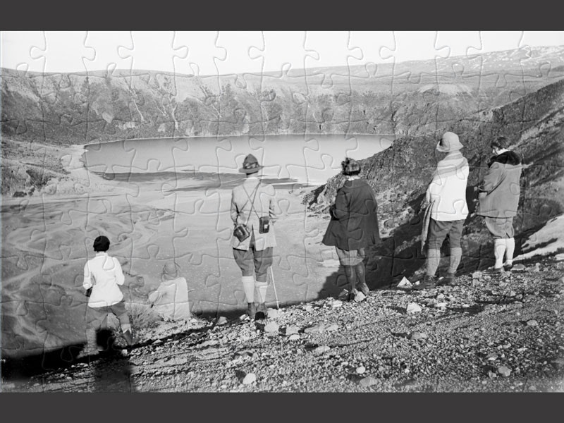 Tongariro National Park - August 1925, August 1925, by Leslie Adkin. Gift of G. L. Adkin family estate, 1964. Te Papa (B.022470) Six people stand on the side of a mountain looking at the view