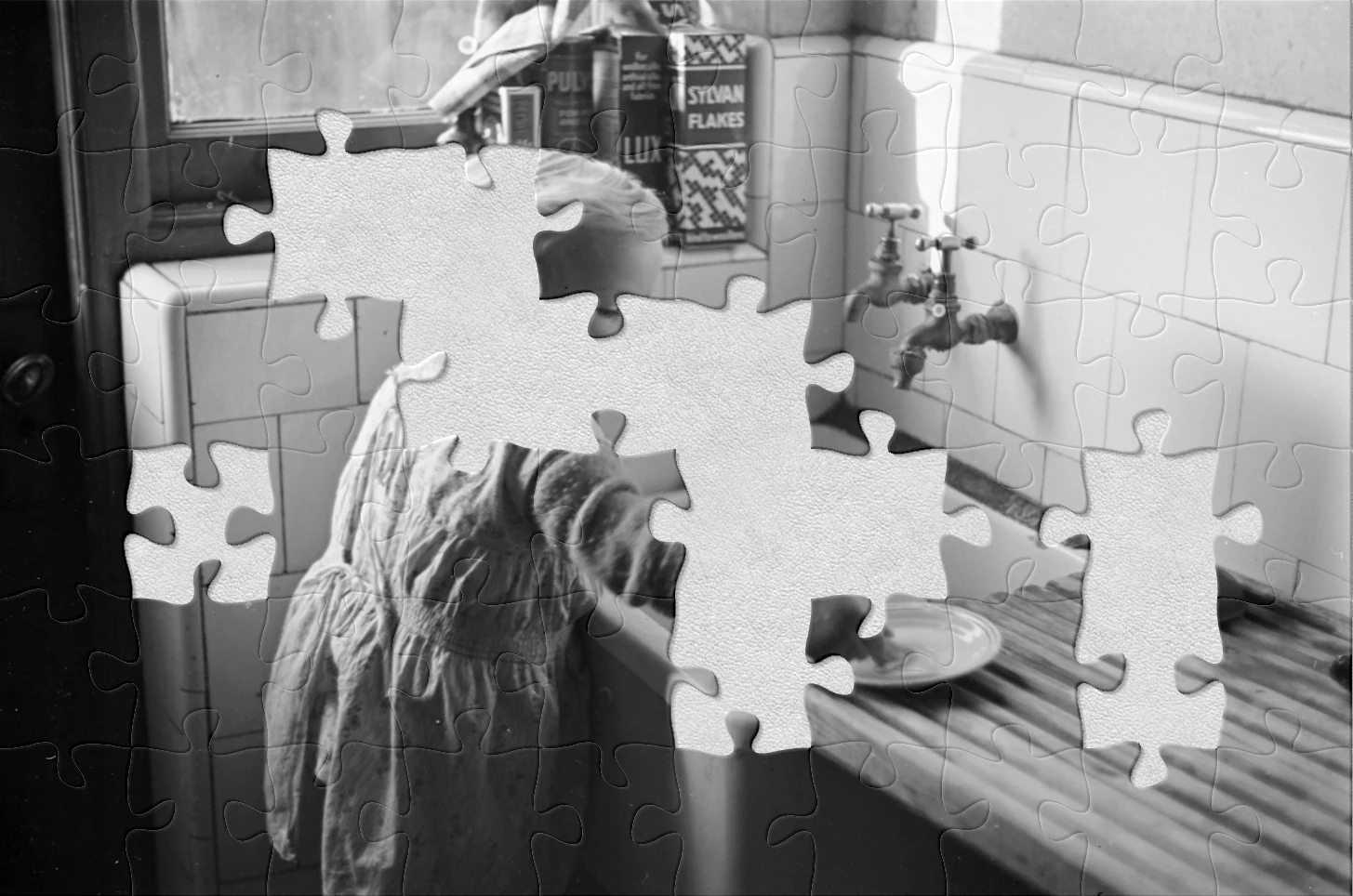 A black and white photo with jigsaw pieces missing