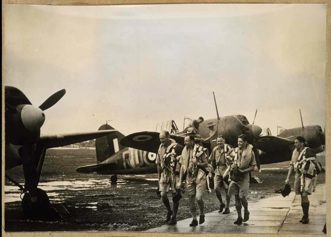 RNZAF soldiers and three planes on an airfield