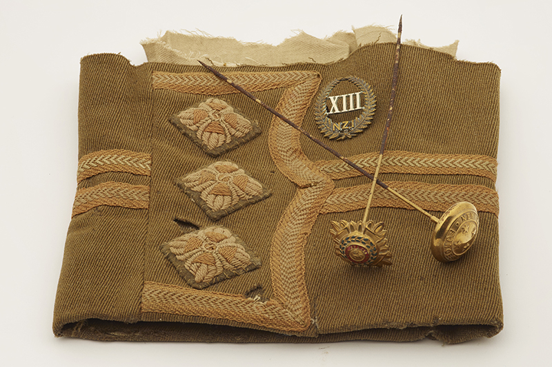 A part of an army uniform sleeve with pins on it