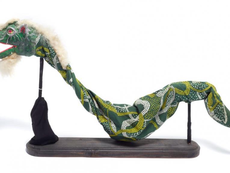 A long dragon puppet supported by two mounts