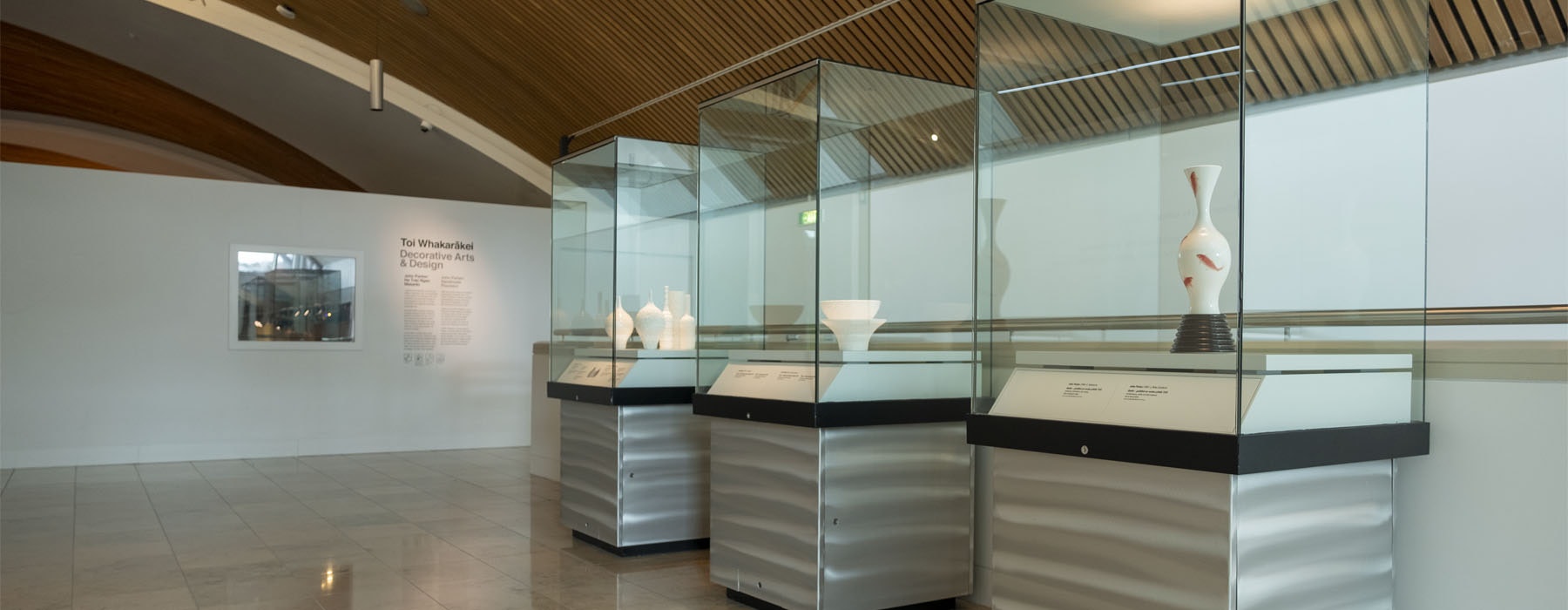 View of the John Parker exhibition, showing three glass plinths containing sculptures