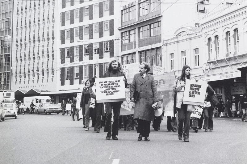Black and white photo of protestors marching down a major road in Wellington’s city centre