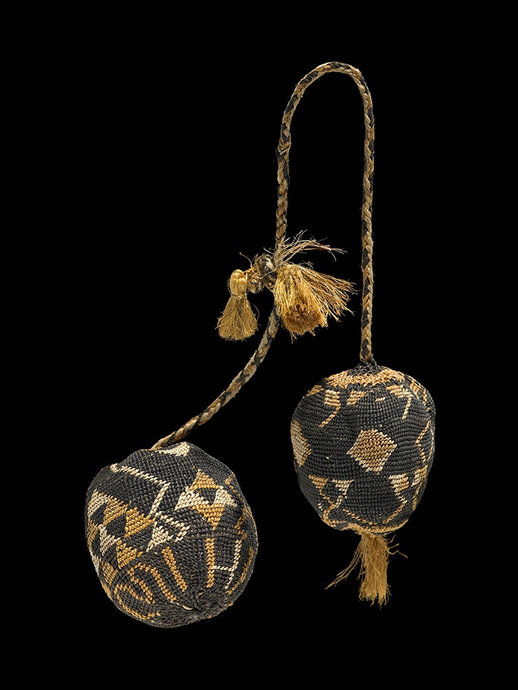 Two balls with Māori weaving designs and the word 'mihi' woven into the material.