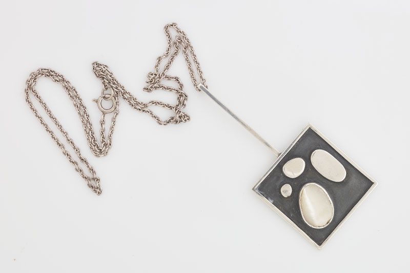 Square pendant with mother of pearl ornaments on it