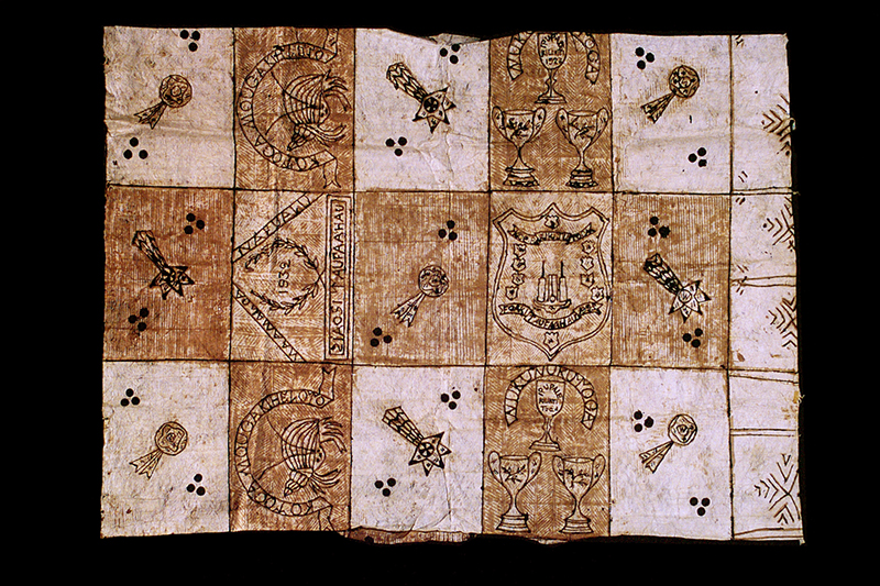 A brown and cream tapa cloth with patterns painted on it.
